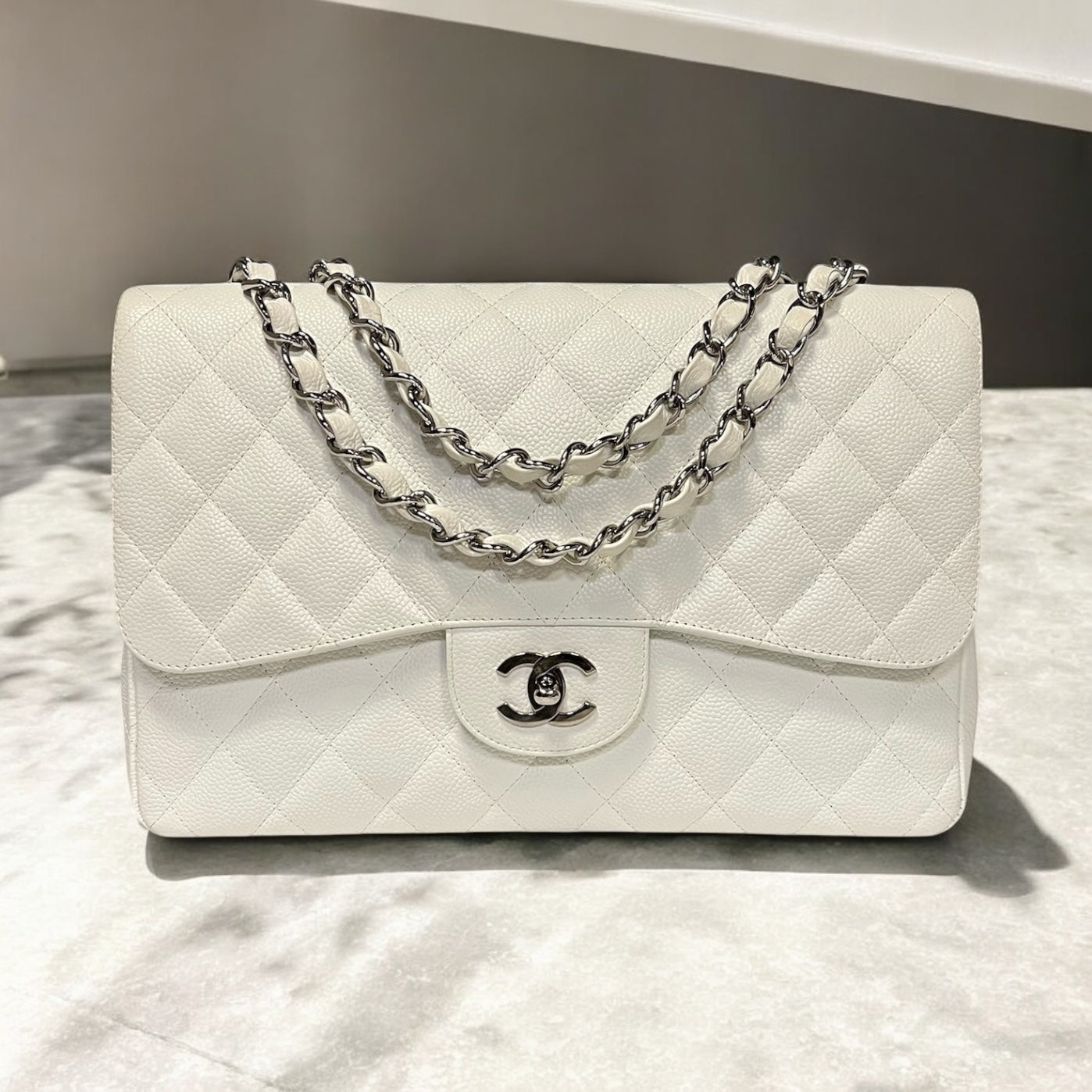 CHANEL Jumbo Classic Flap Bag in White Caviar Leather